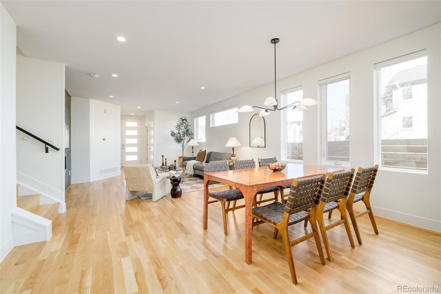 dining area with a chandelier and light wood-type flooring