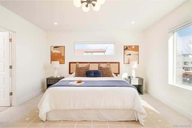 bedroom featuring light carpet and multiple windows