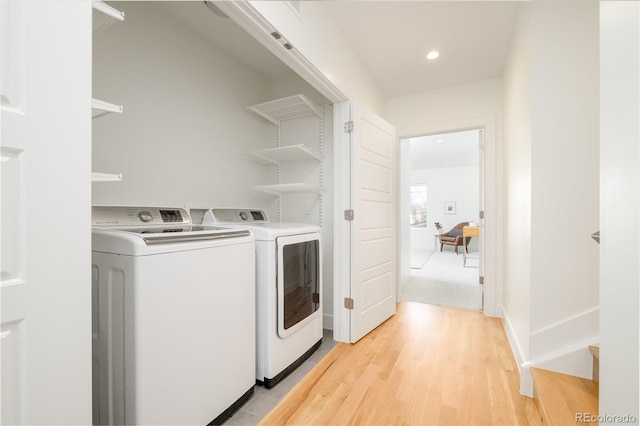 washroom featuring washer and dryer and light wood-type flooring