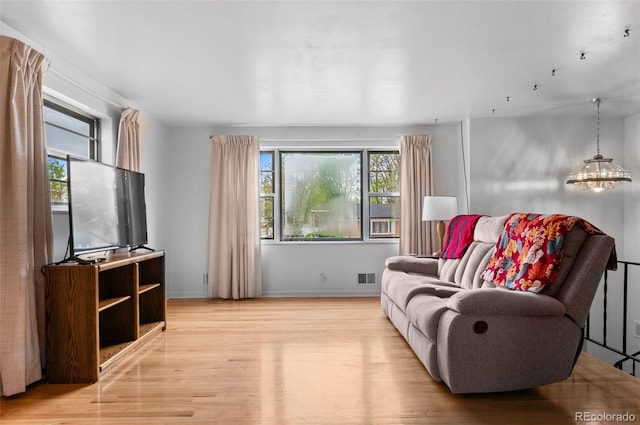 sitting room with light wood-style flooring and baseboards
