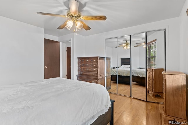 bedroom with wood finished floors, a closet, and a ceiling fan