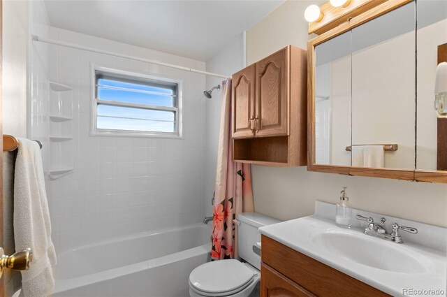 bathroom featuring toilet, vanity, and shower / bath combo with shower curtain