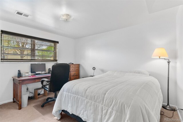 bedroom featuring light carpet and baseboards