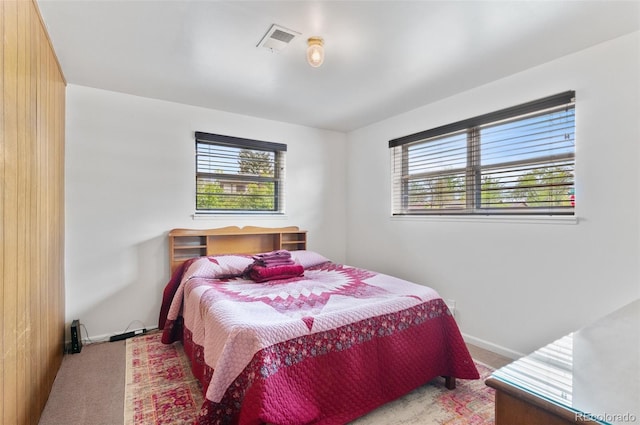 carpeted bedroom with multiple windows and baseboards