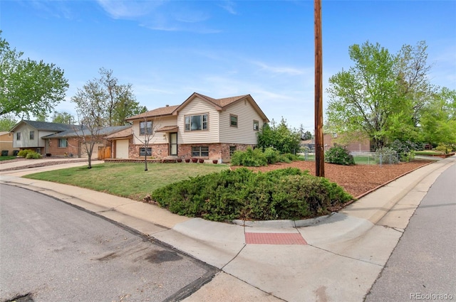 view of front of home featuring a garage, brick siding, concrete driveway, and a front yard