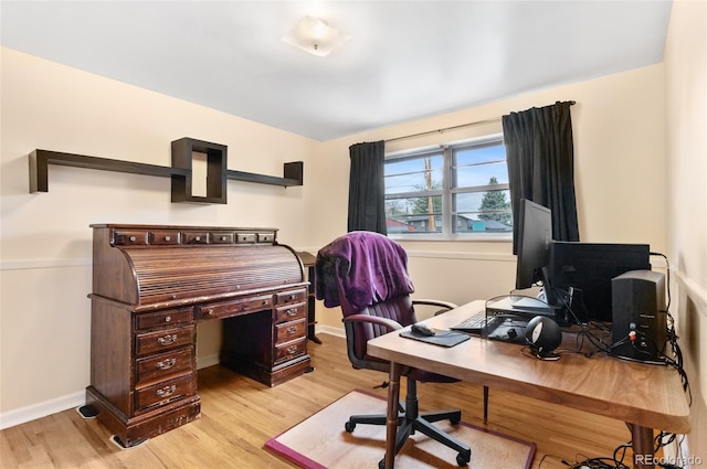 home office featuring light wood finished floors and baseboards