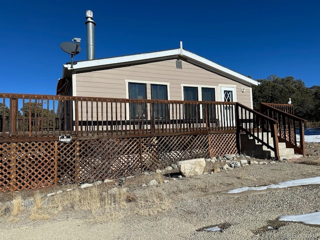 back of house with a wooden deck