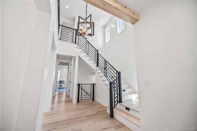 10757 Timberdash Ave, Highlands Ranch, CO 80126 - stairs featuring a chandelier, wood finished floors, recessed lighting, and a high ceiling