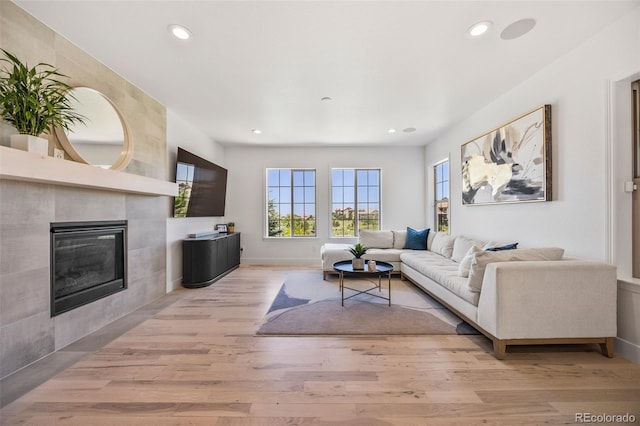 10757 Timberdash Ave, Highlands Ranch, CO 80126 - living room with wood finished floors, recessed lighting, and a tile fireplace