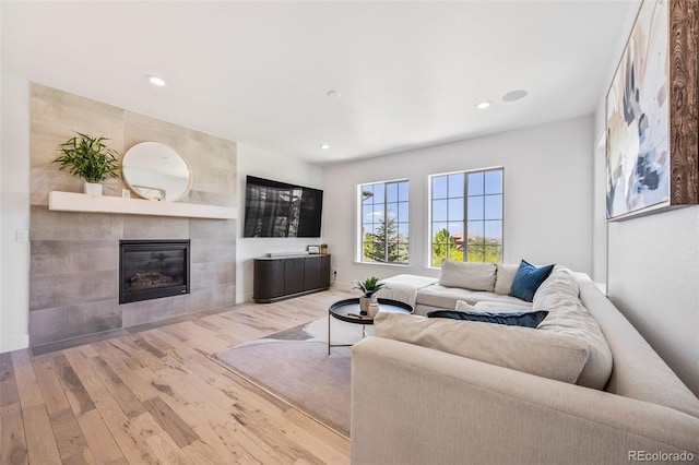 10757 Timberdash Ave, Highlands Ranch, CO 80126 - living room with wood finished floors, recessed lighting, and a tiled fireplace