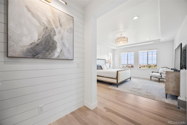 10757 Timberdash Ave, Highlands Ranch, CO 80126 - bedroom with wood finished floors, a tray ceiling, wooden walls, and recessed lighting
