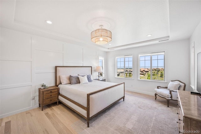 10757 Timberdash Ave, Highlands Ranch, CO 80126 - bedroom with a tray ceiling, light wood-style flooring, and recessed lighting
