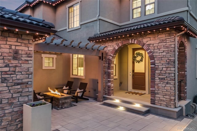 10757 Timberdash Ave, Highlands Ranch, CO 80126 - entrance to property featuring a tile roof, stucco siding, and stone siding