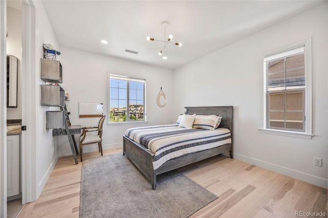 10757 Timberdash Ave, Highlands Ranch, CO 80126 - bedroom with light wood finished floors, a chandelier, and recessed lighting