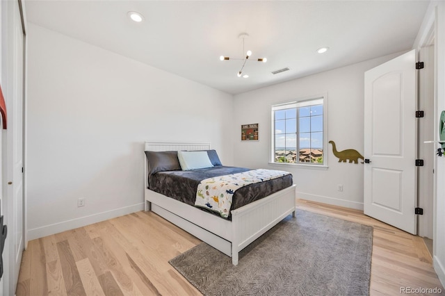 10757 Timberdash Ave, Highlands Ranch, CO 80126 - bedroom with light wood finished floors, a chandelier, and recessed lighting