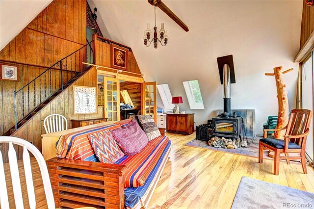 living room with light hardwood / wood-style floors, a wood stove, and plenty of natural light