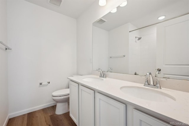 24790 E 39th Ave, Aurora, CO 80019 - bathroom with toilet, wood finished floors, baseboards, a shower, and double vanity