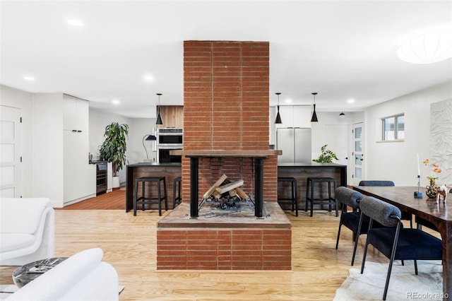 1330 Olive St, Denver, CO 80220 - living room featuring light wood-type flooring, wine cooler, recessed lighting, and baseboards