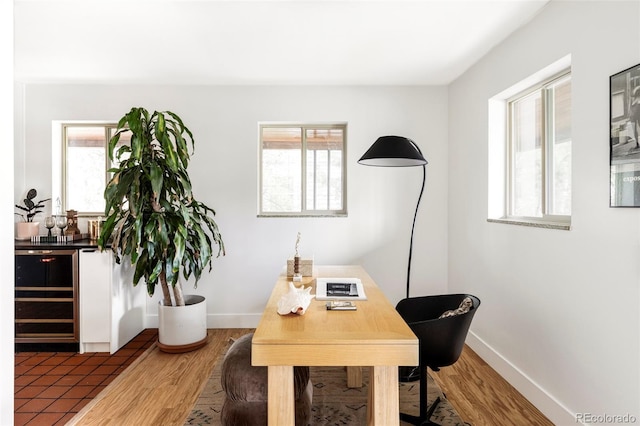 1330 Olive St, Denver, CO 80220 - home office featuring wine cooler, wood finished floors, and baseboards