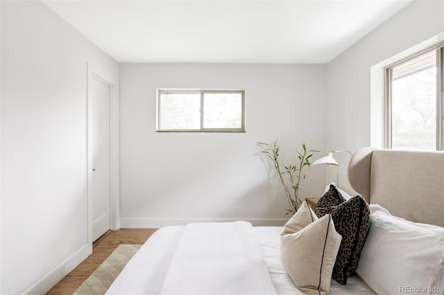 1330 Olive St, Denver, CO 80220 - bedroom with multiple windows, light wood-type flooring, and baseboards