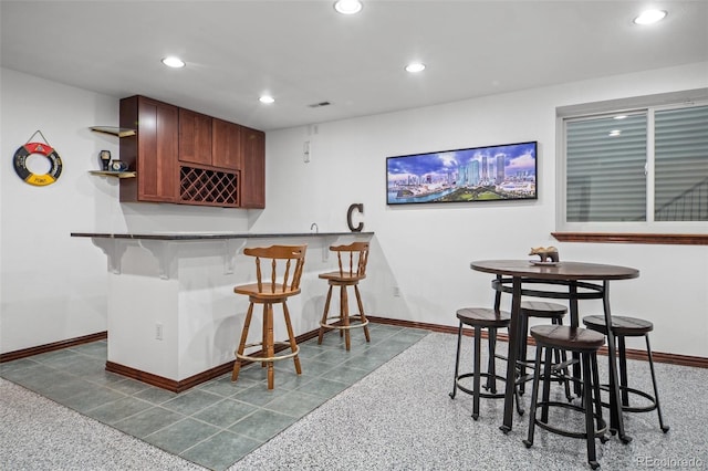 bar with visible vents, indoor wet bar, baseboards, and recessed lighting
