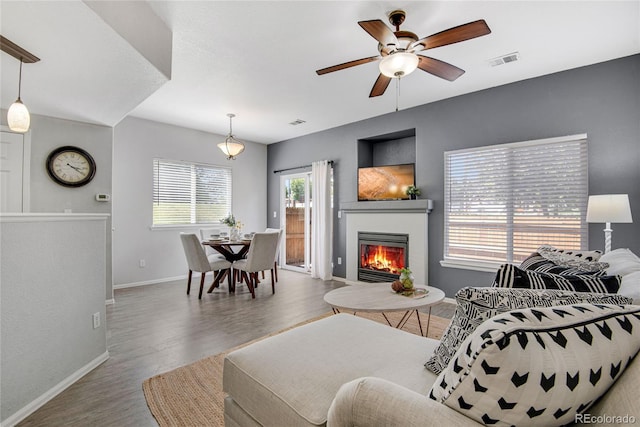 9080 Gale Blvd Unit 4, Thornton, CO 80260 - living area featuring ceiling fan, baseboards, wood finished floors, and a glass covered fireplace