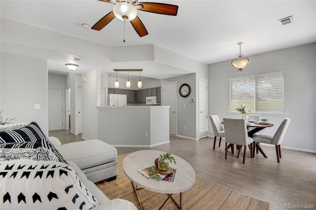 9080 Gale Blvd Unit 4, Thornton, CO 80260 - living area featuring a ceiling fan, baseboards, and light wood-style floors