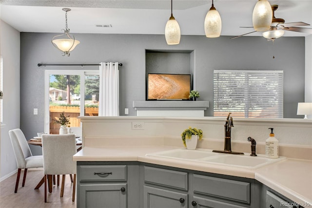9080 Gale Blvd Unit 4, Thornton, CO 80260 - kitchen featuring gray cabinets, a sink, ceiling fan, hanging light fixtures, and light countertops