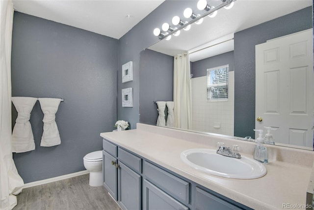 9080 Gale Blvd Unit 4, Thornton, CO 80260 - full bathroom with toilet, wood finished floors, vanity, baseboards, and a shower with shower curtain