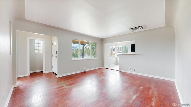 unfurnished living room with a wealth of natural light and visible vents