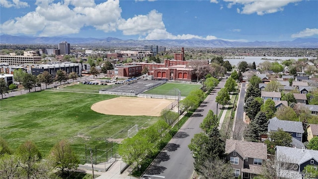drone / aerial view featuring a city view and a mountain view