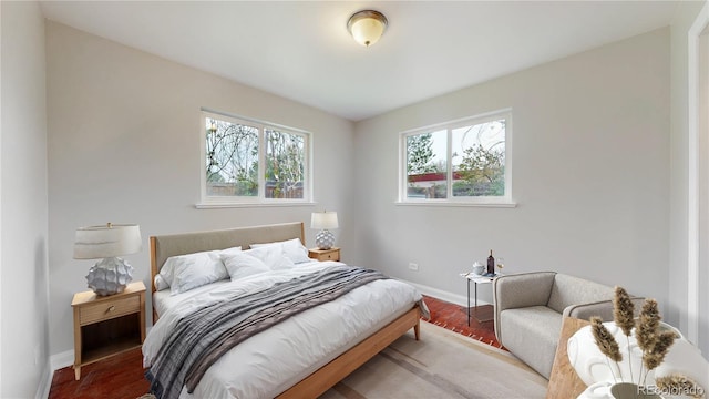 bedroom with wood finished floors and baseboards