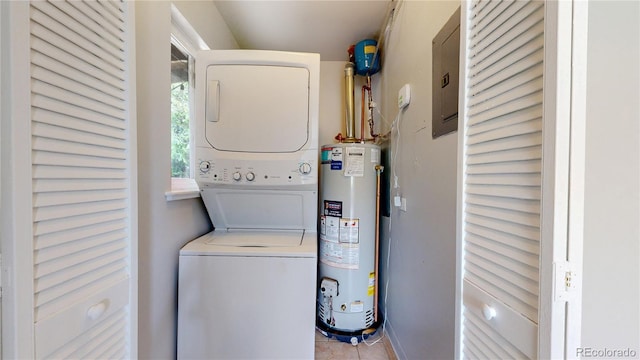 laundry area featuring stacked washer and clothes dryer, gas water heater, tile patterned floors, and electric panel