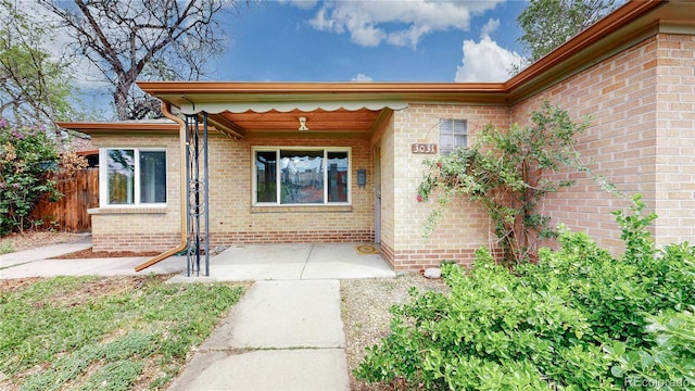 view of exterior entry with fence