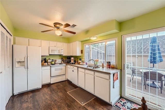 kitchen with white cabinets, ceiling fan, dark wood-type flooring, sink, and white appliances