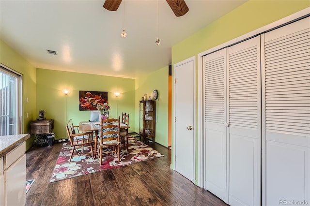 dining space with dark hardwood / wood-style floors and ceiling fan