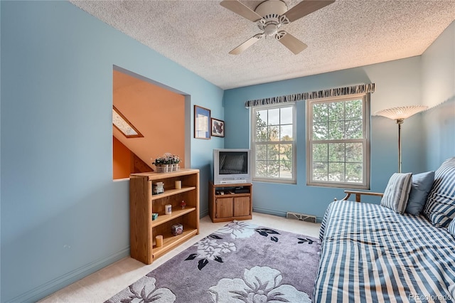 bedroom with ceiling fan, a textured ceiling, and light colored carpet