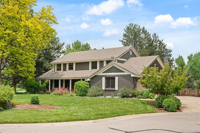 6128 S Coventry Ln E, Littleton, CO 80123 - traditional-style house featuring a tile roof and a chimney