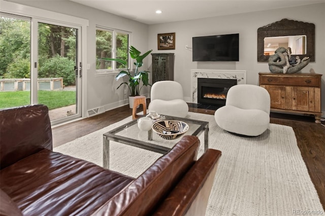 6128 S Coventry Ln E, Littleton, CO 80123 - living area featuring dark wood-style floors, a high end fireplace, recessed lighting, and baseboards