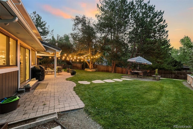 6128 S Coventry Ln E, Littleton, CO 80123 - yard at dusk featuring a patio area