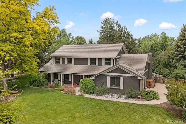 6128 S Coventry Ln E, Littleton, CO 80123 - view of front of home featuring a tile roof, a front lawn, a porch, and a chimney