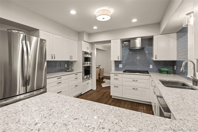 6128 S Coventry Ln E, Littleton, CO 80123 - kitchen featuring stainless steel appliances, a sink, wall chimney exhaust hood, decorative backsplash, and dark wood-style floors
