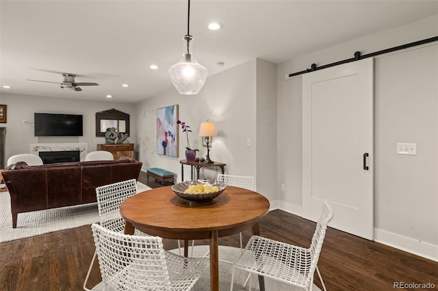 6128 S Coventry Ln E, Littleton, CO 80123 - dining room with a barn door, dark wood finished floors, a ceiling fan, recessed lighting, and baseboards
