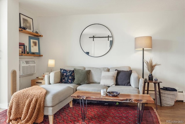 living area featuring an AC wall unit and wood finished floors