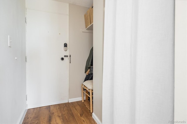 interior space featuring baseboards and wood finished floors