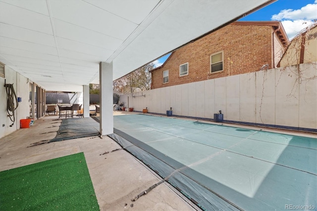 view of swimming pool featuring a fenced backyard and a patio area