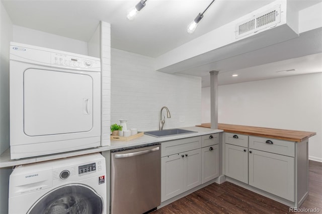 2845 Eaton St, Wheat Ridge, CO 80214 - laundry room featuring stacked washing machine and dryer and dark wood-style floors
