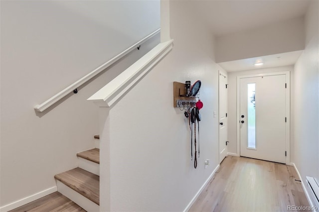 foyer featuring light wood-type flooring and a baseboard radiator