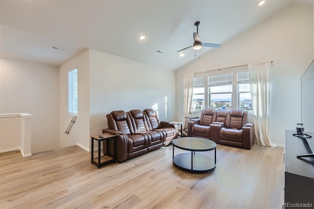 living room featuring lofted ceiling, light wood-type flooring, and ceiling fan