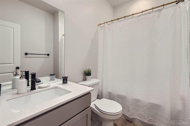 bathroom with toilet and vanity